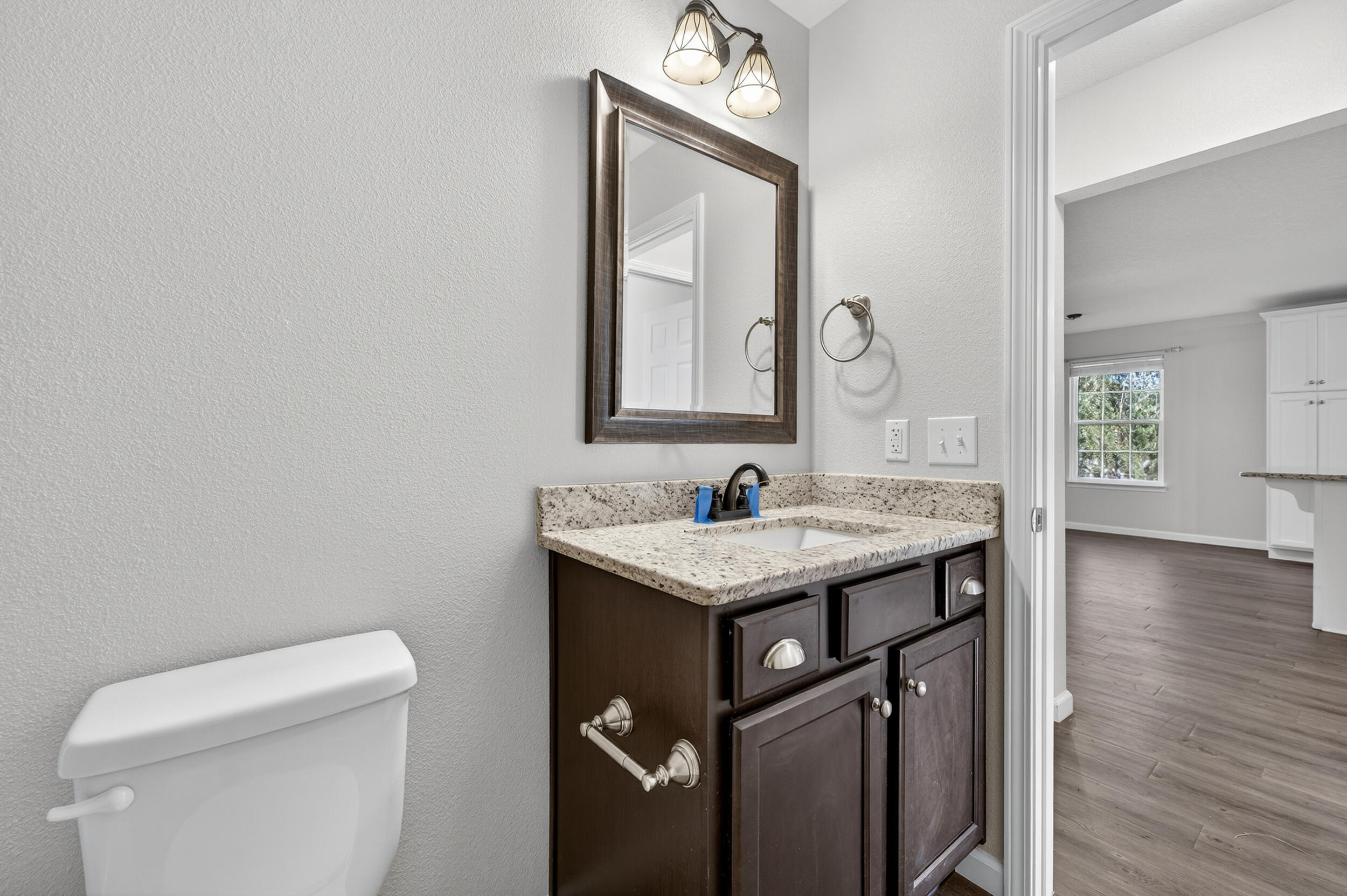 1833 Gainer Avenue Baker, FL 32531 - Photo 28 of 43 a bath room with a toilet a sink and a mirror