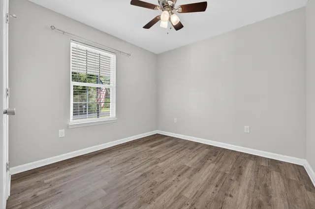 wooden floor in an empty room with a window
