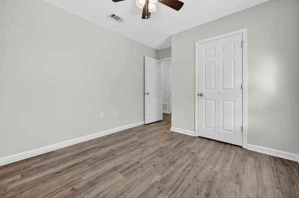 a view of an empty room with wooden floor