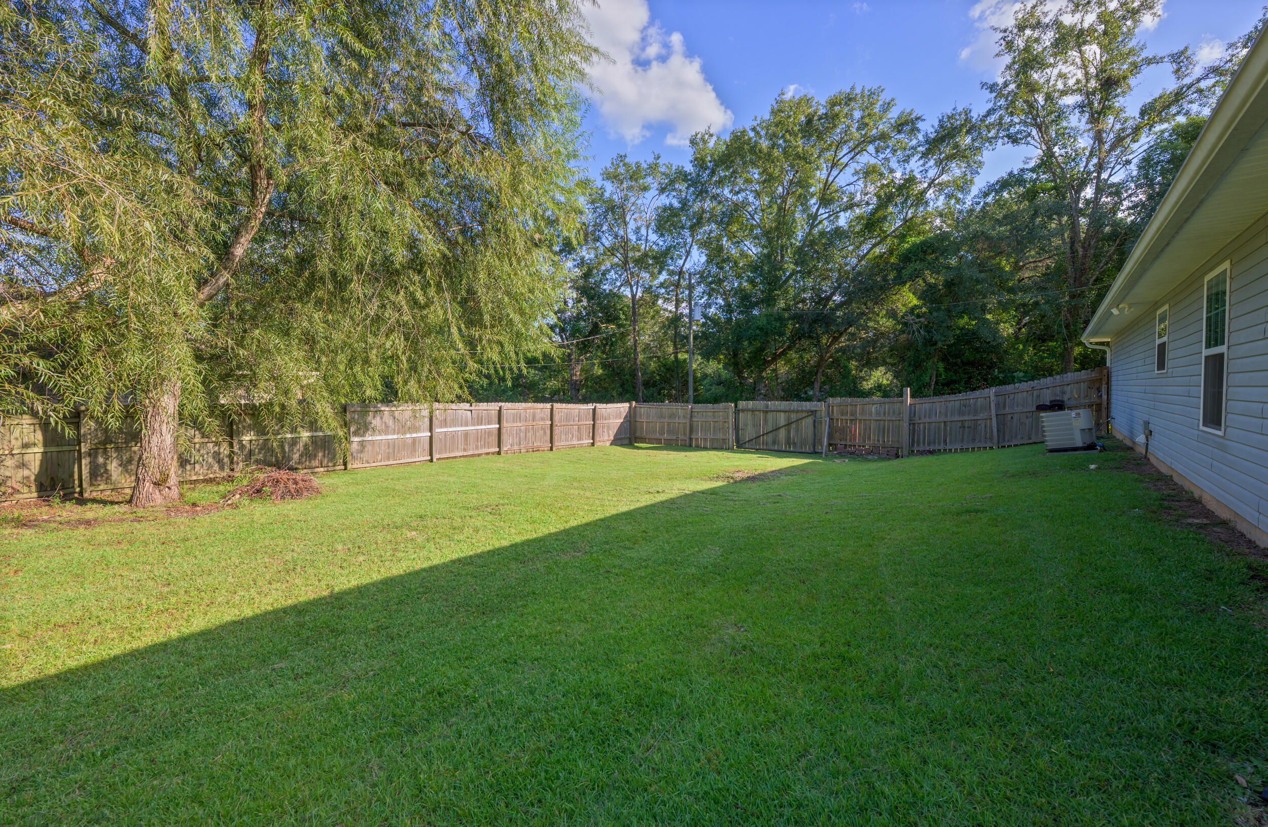 1833 Gainer Avenue Baker, FL 32531 - Photo 37 of 43 a view of yard with swimming pool and trees in the background