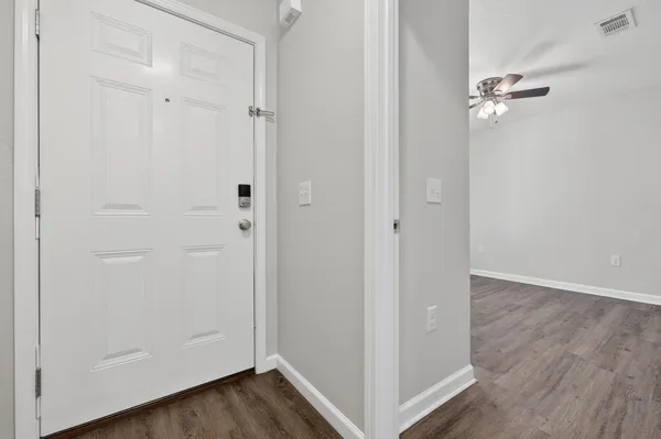 a view of empty room with wooden floor