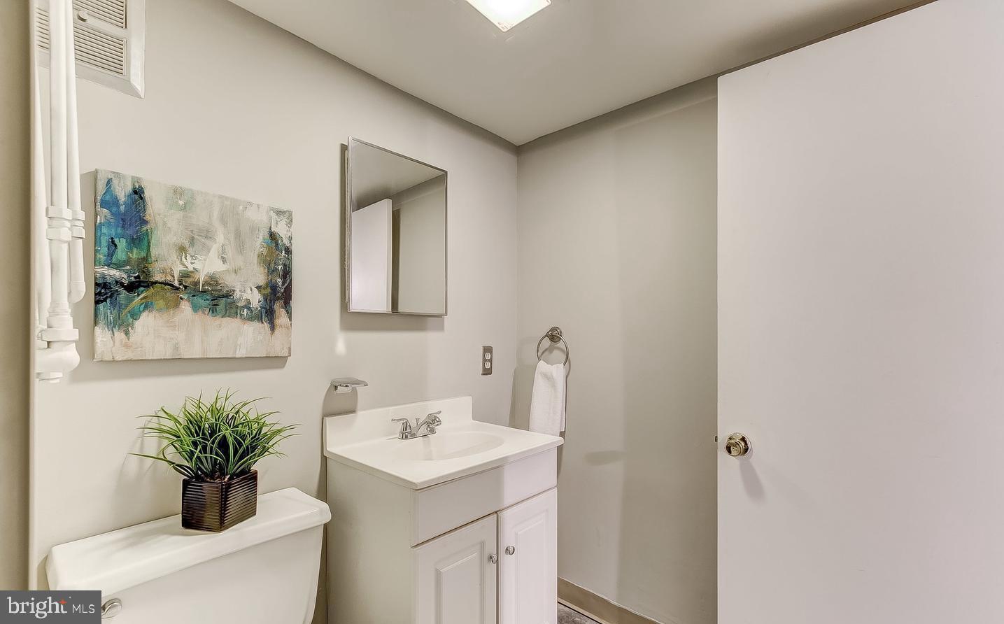 825 South Charles Street Baltimore, MD 21230 - Photo 23 of 34 a bathroom with a sink mirror and vanity