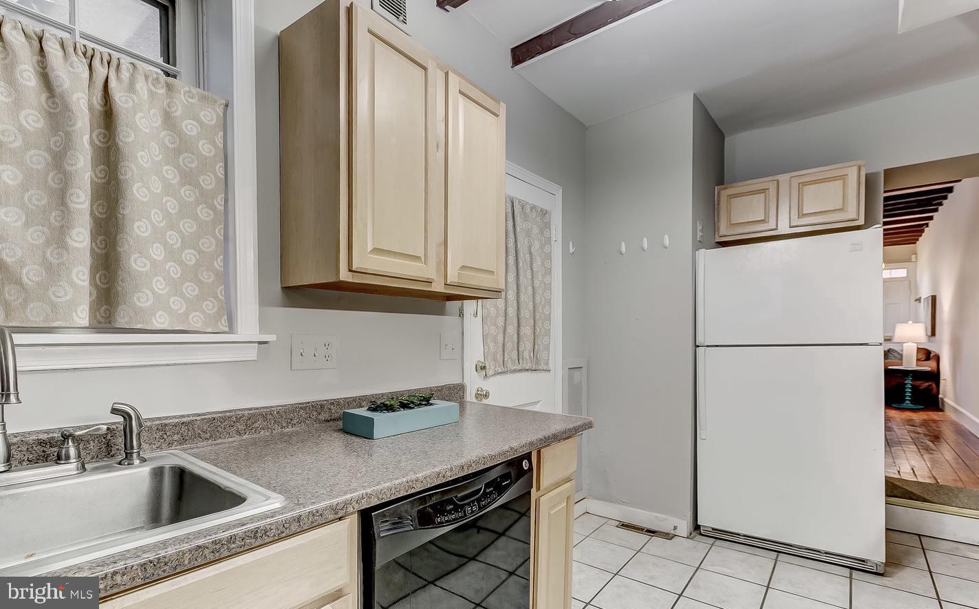 825 South Charles Street Baltimore, MD 21230 - Photo 4 of 34 a kitchen with stainless steel appliances granite countertop a refrigerator sink and cabinets