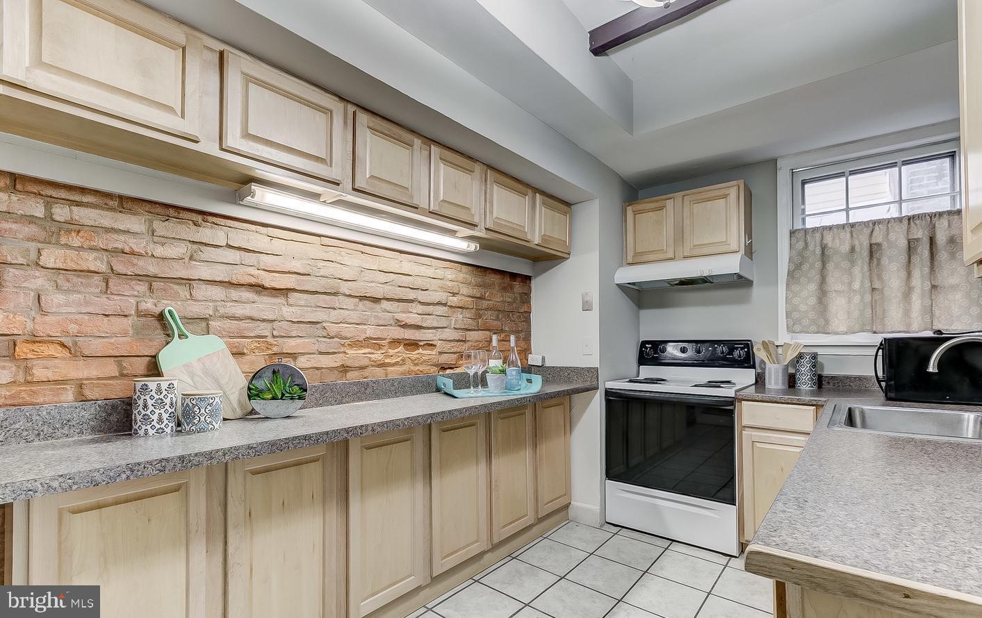 825 South Charles Street Baltimore, MD 21230 - Photo 5 of 34 a kitchen with stainless steel appliances granite countertop a sink stove and cabinets
