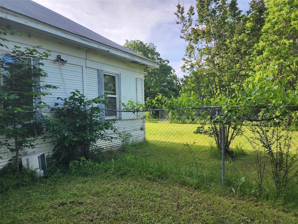 403 Barker Street Cumby, TX 75433 - Photo 15 of 16 White siding exterior with a dark roofline, featuring multiple windows
