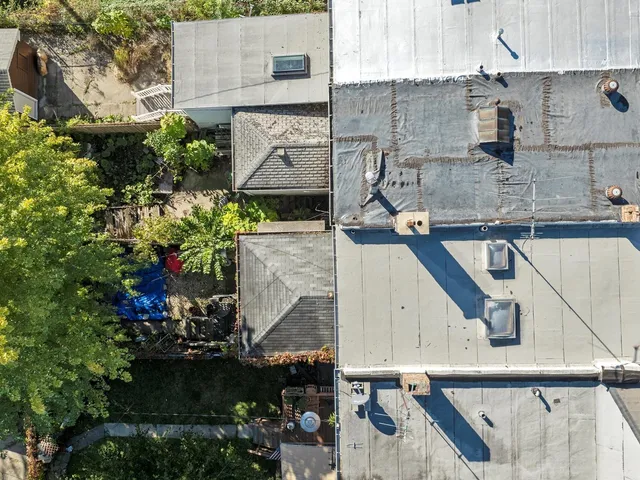 an aerial view of a house with a yard and garden