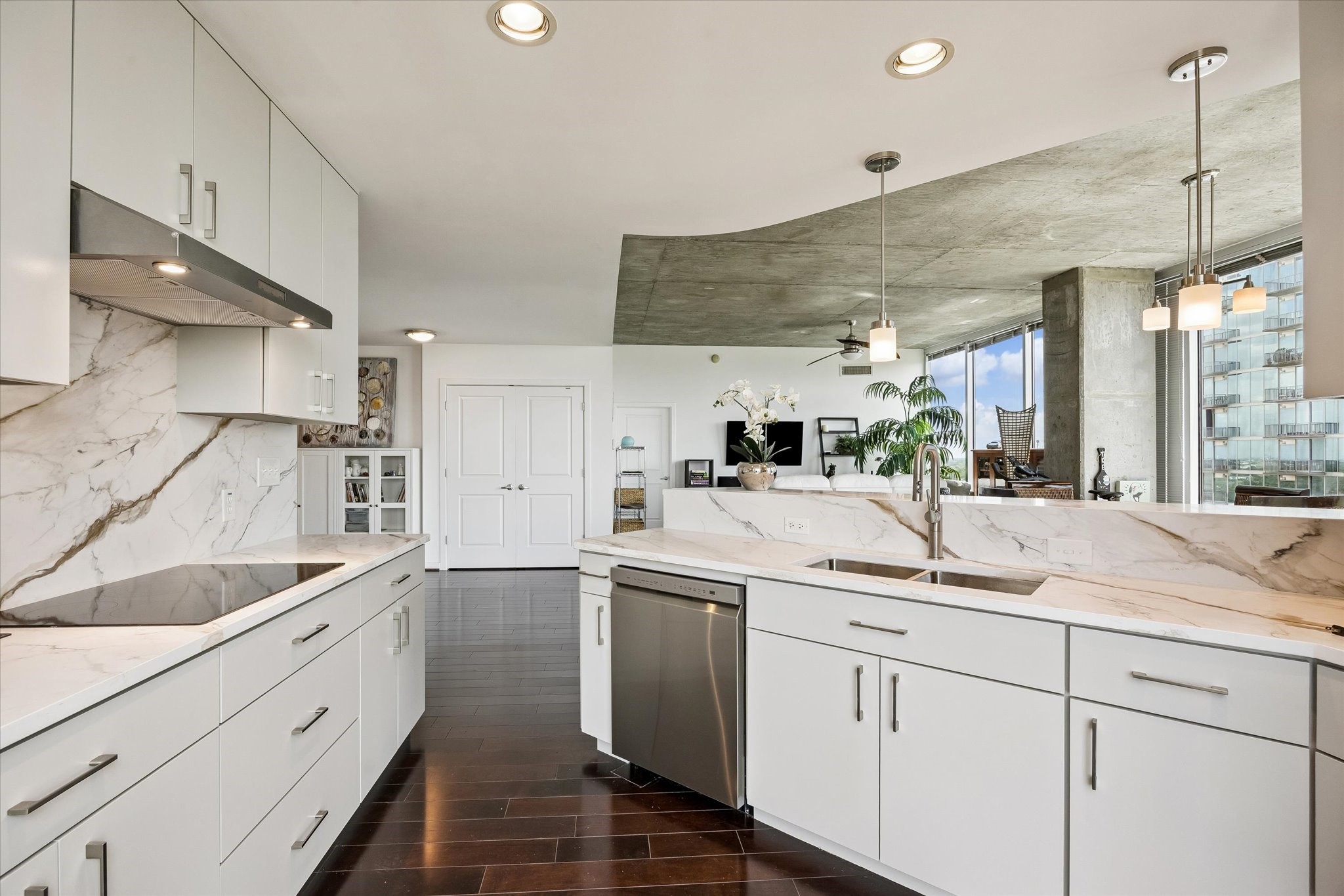 5925 Almeda Road, Unit 11218 Houston, TX 77004 - Photo 4 of 39 a kitchen with a sink dishwasher and white cabinets with wooden floor