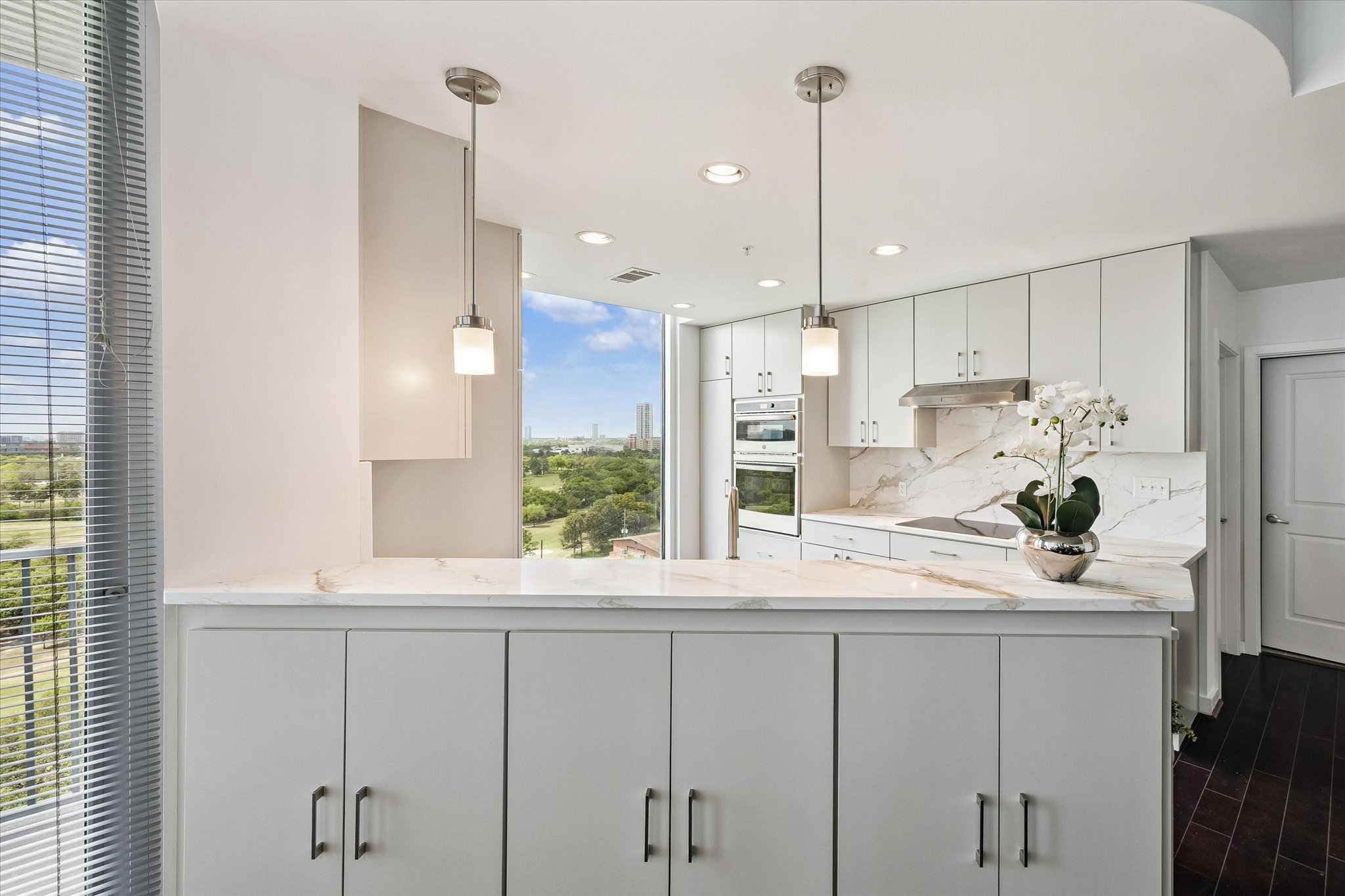 5925 Almeda Road, Unit 11218 Houston, TX 77004 - Photo 7 of 39 a kitchen with kitchen island white cabinets and refrigerator