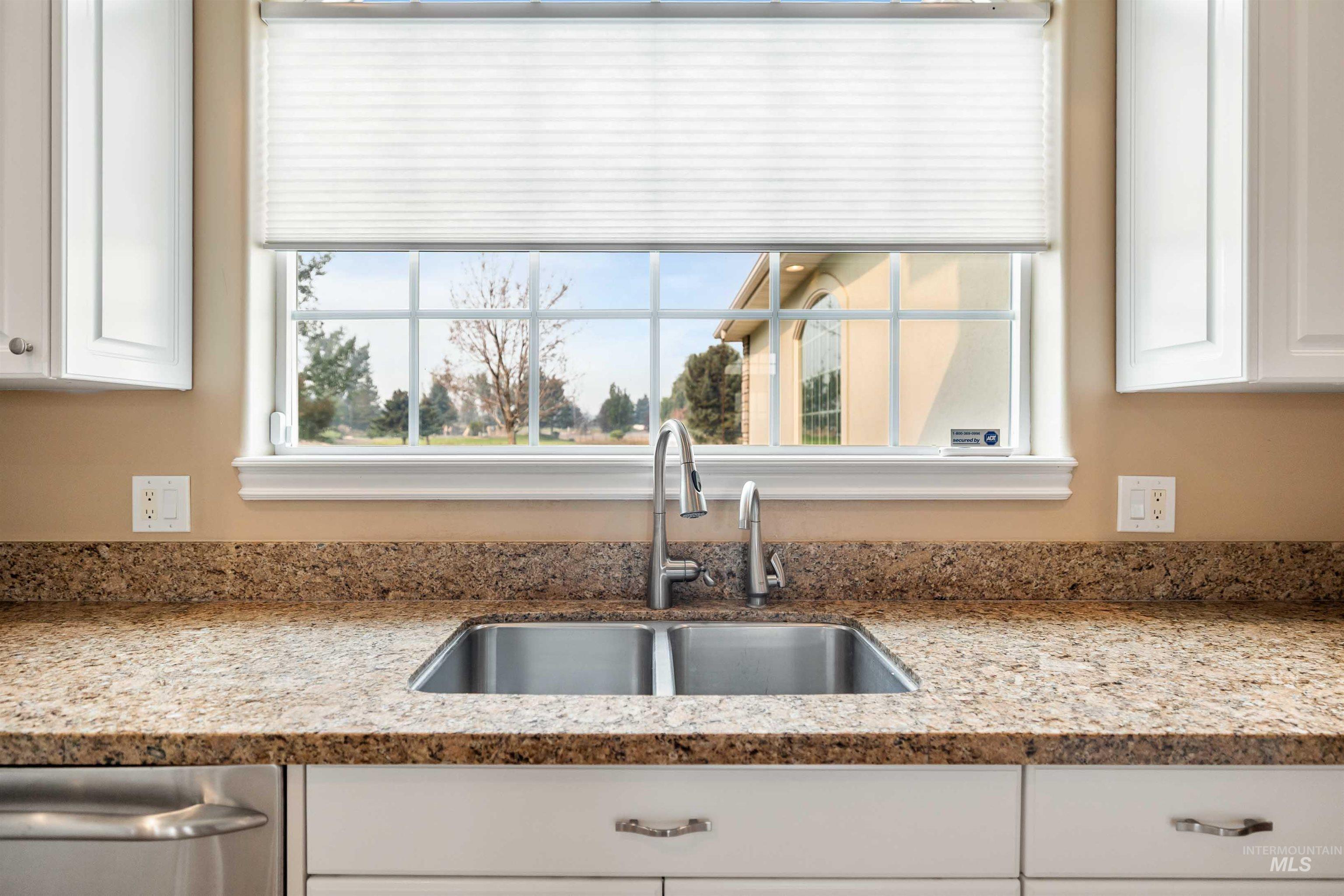 3404 Ridge Line Drive Kimberly, ID 83341 - Photo 10 of 50 Kitchen window framing outdoor scenery, featuring a double basin stainless steel sink with a gooseneck faucet