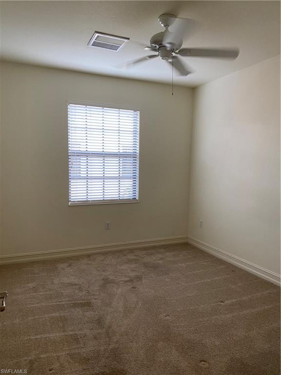 9151 Delano Street, Unit 9702 Naples, FL 34113 - Photo 12 of 14 an empty room with a window and a ceiling fan
