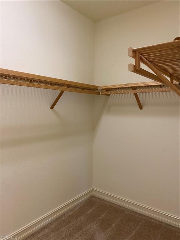 9151 Delano Street, Unit 9702 Naples, FL 34113 - Photo 9 of 14 a view of a room with racks on the wall