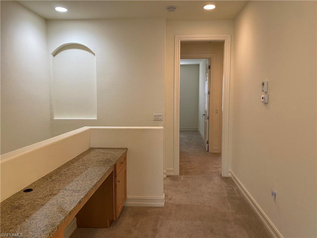 9151 Delano Street, Unit 9702 Naples, FL 34113 - Photo 10 of 14 a bathroom with a granite countertop sink and a mirror