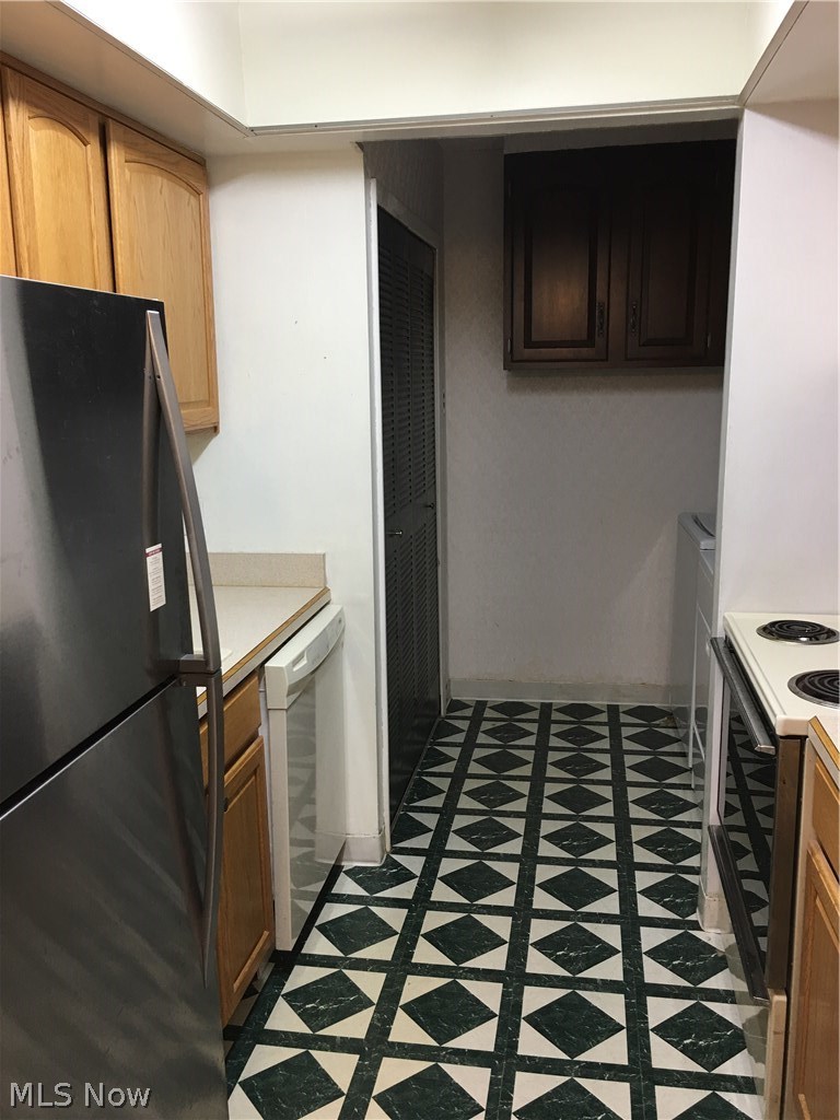 4940 Friar Road, Unit D Stow, OH 44224 - Photo 7 of 23 Updated kitchen cabinets, an electric stove and dishwasher. In the laundry space there is a Kenmore washer and Whirlpool electric dryer. Storage with extra overhead cabinets in the laundry area will come in handy!