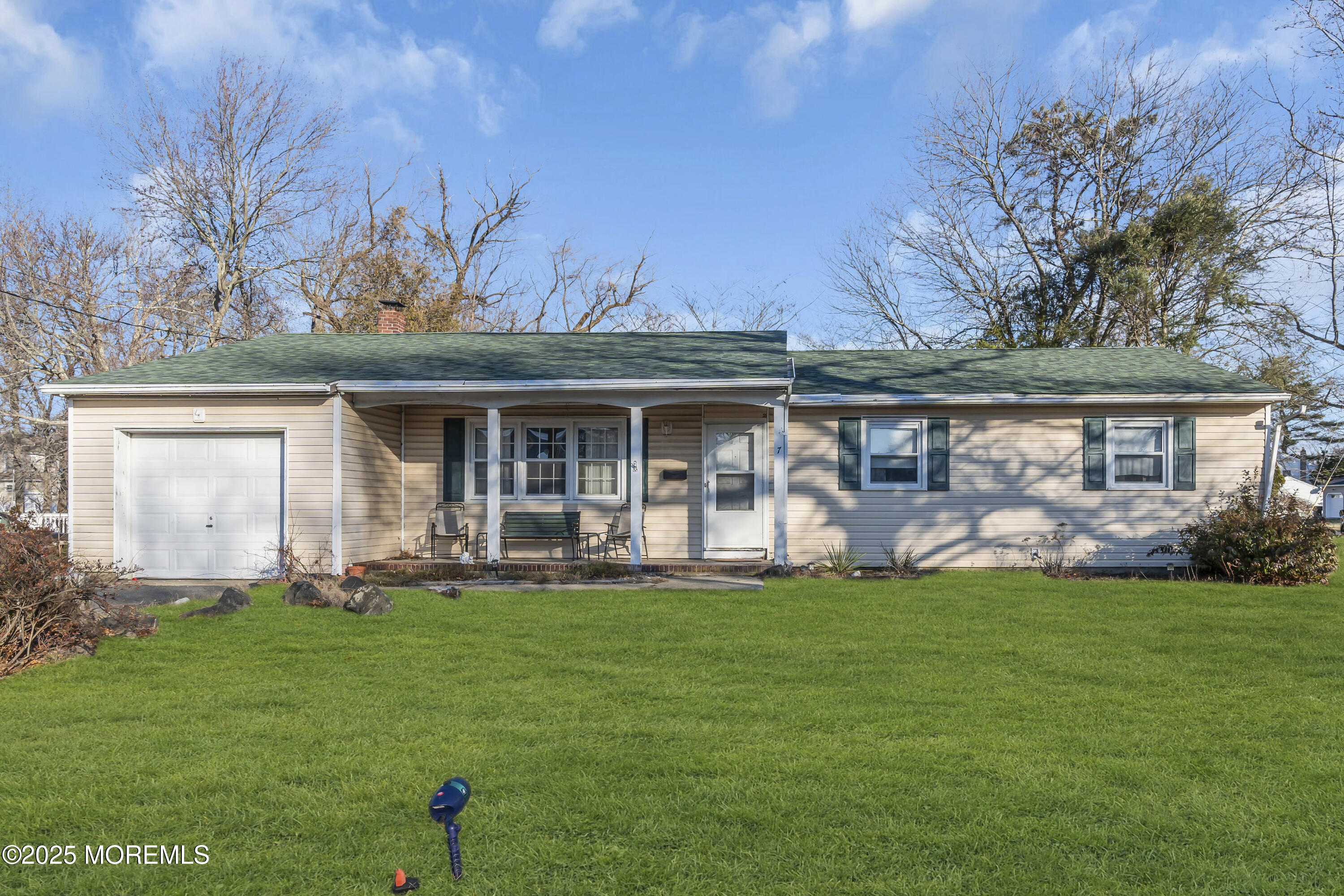 7 Whalepond Road Oakhurst, NJ 07755 - Photo 1 of 23 a front view of a house with a garden and patio