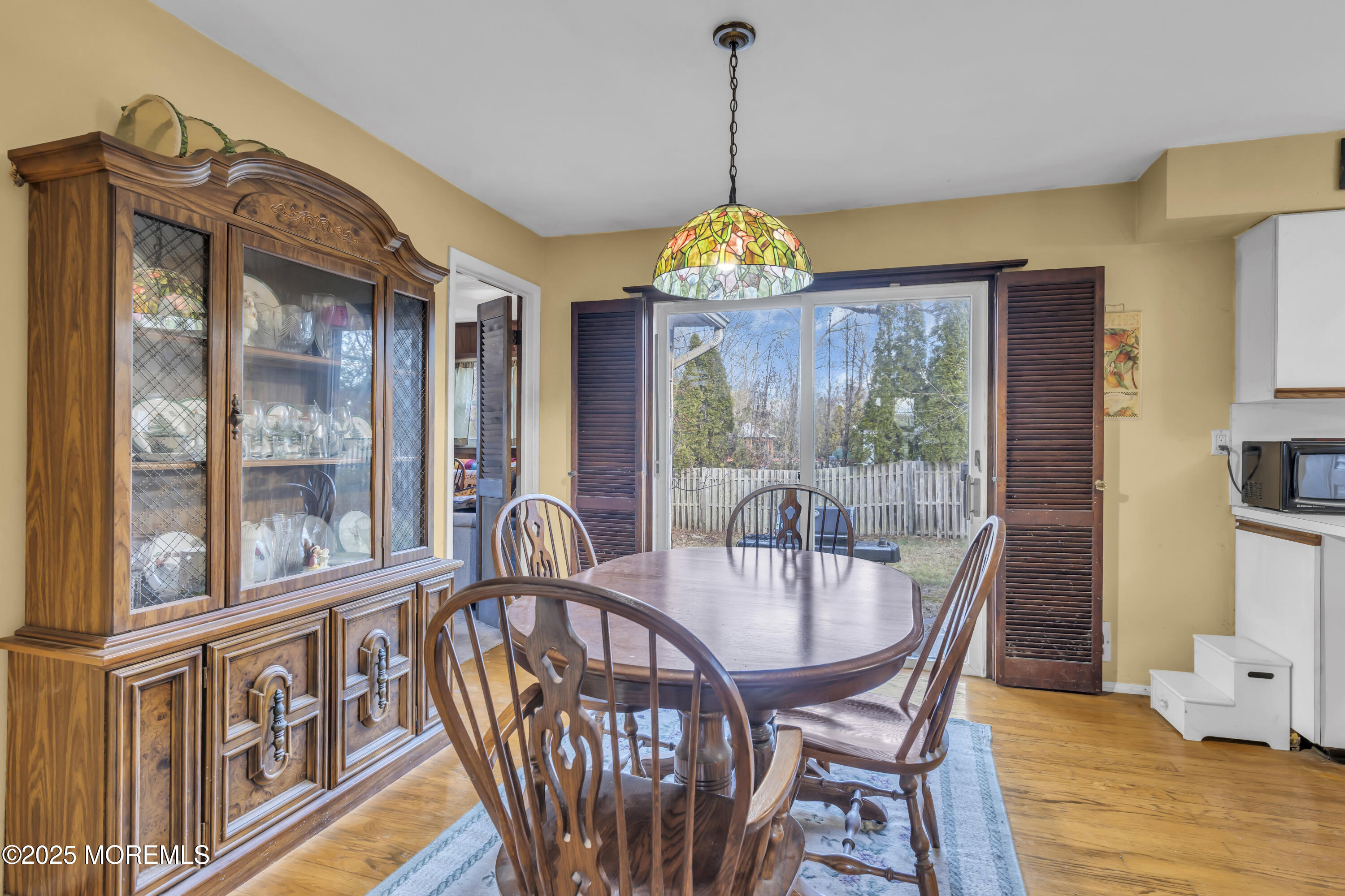 7 Whalepond Road Oakhurst, NJ 07755 - Photo 15 of 23 a view of a dining room with furniture wooden floor and chandelier