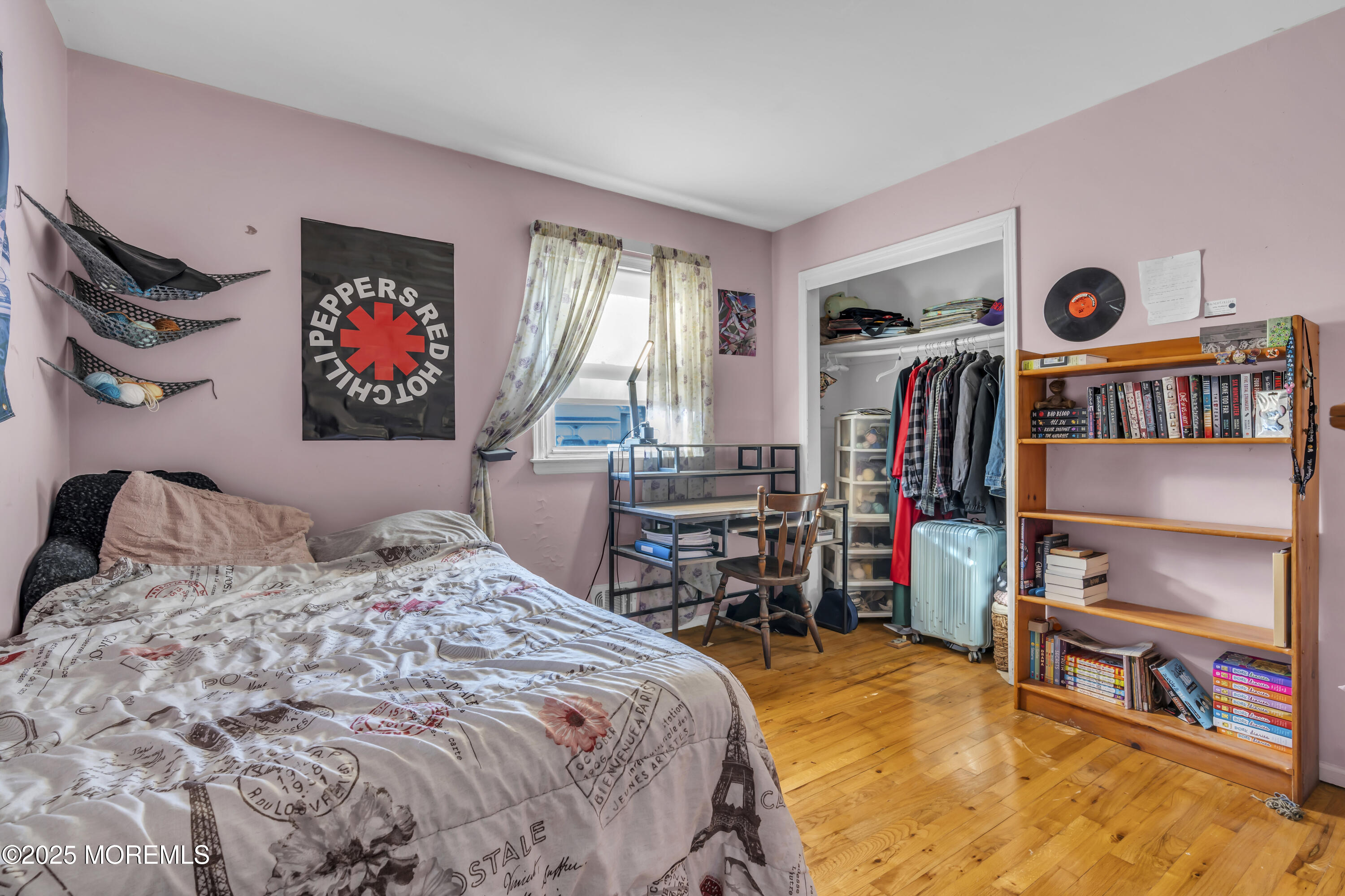 7 Whalepond Road Oakhurst, NJ 07755 - Photo 18 of 23 a bedroom with a bed and a book shelf
