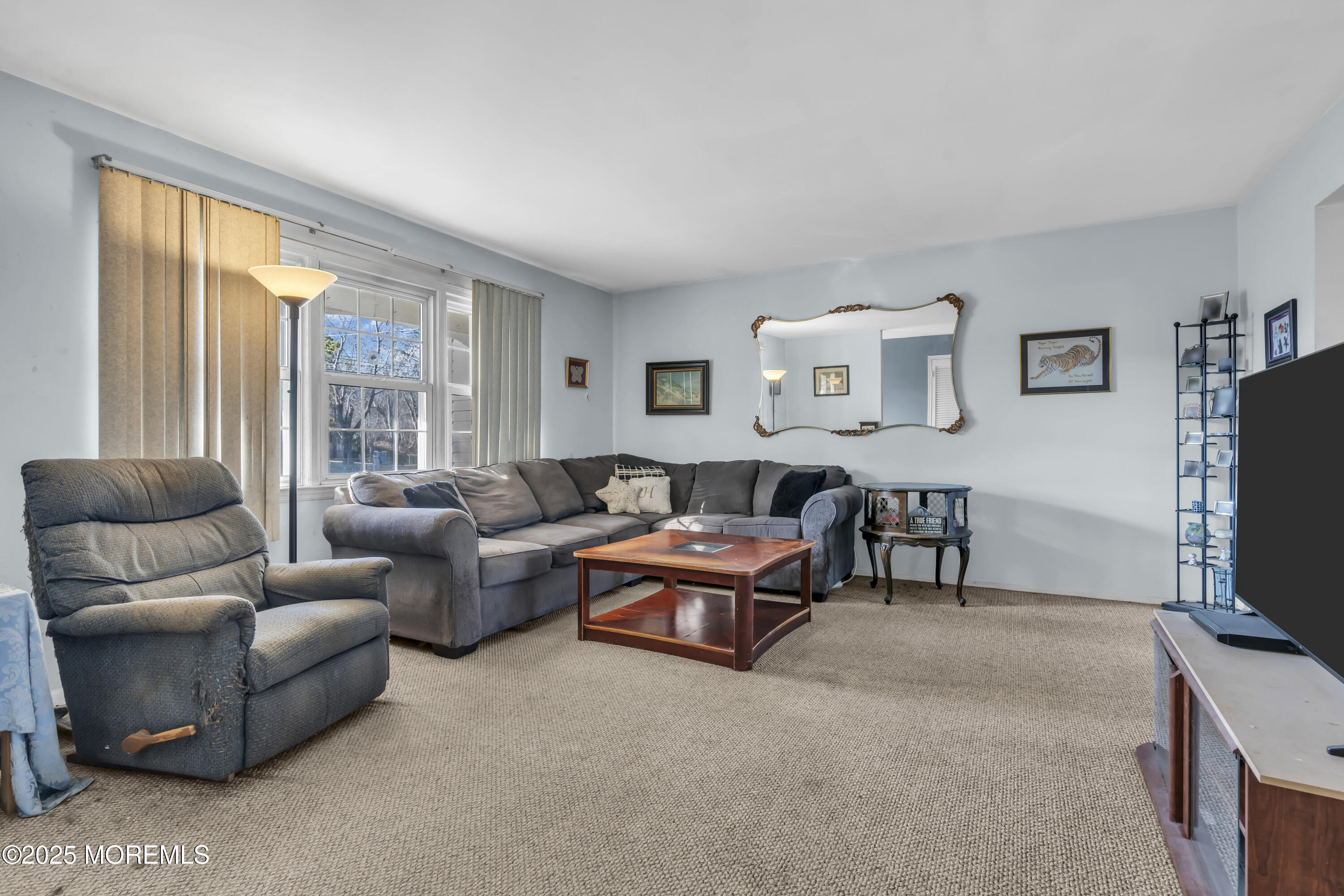 7 Whalepond Road Oakhurst, NJ 07755 - Photo 8 of 23 a living room with furniture and a flat screen tv