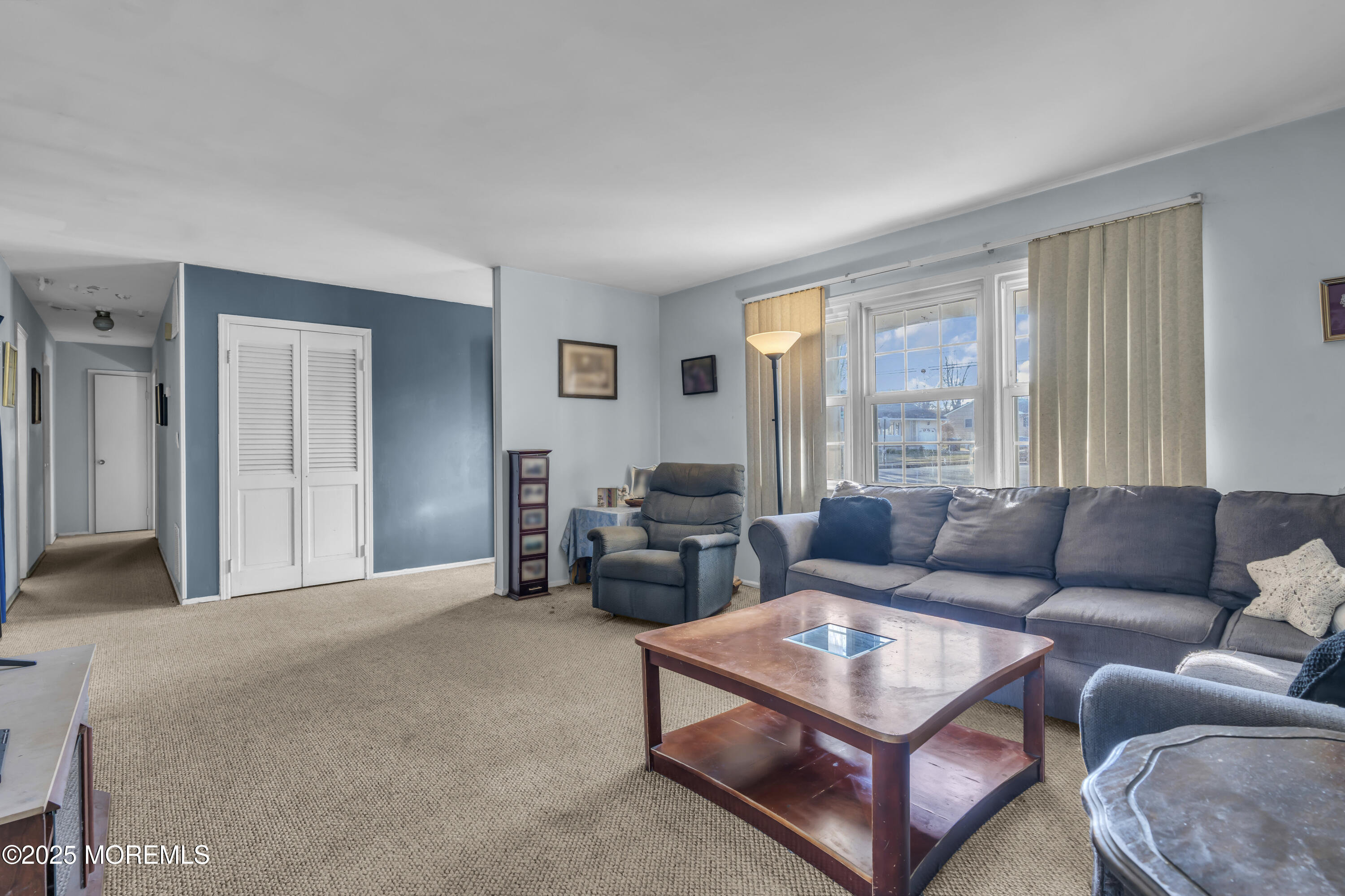 7 Whalepond Road Oakhurst, NJ 07755 - Photo 9 of 23 a living room with furniture and a large window