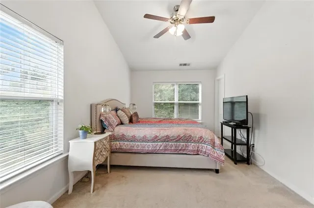 a bedroom with a bed wooden floor and window