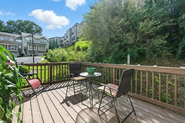 a view of a chairs and table on the wooden deck
