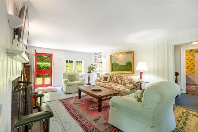 a living room with fireplace furniture and a flat screen tv
