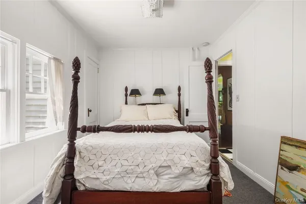 a bed sitting in a bedroom next to a window