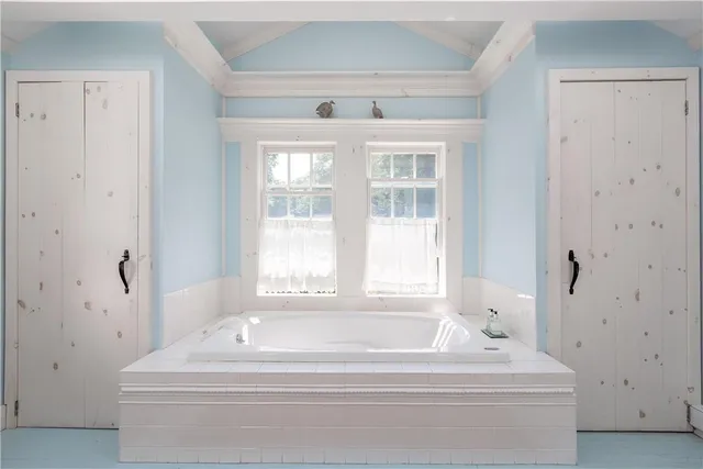 a bathroom with bathtub and window