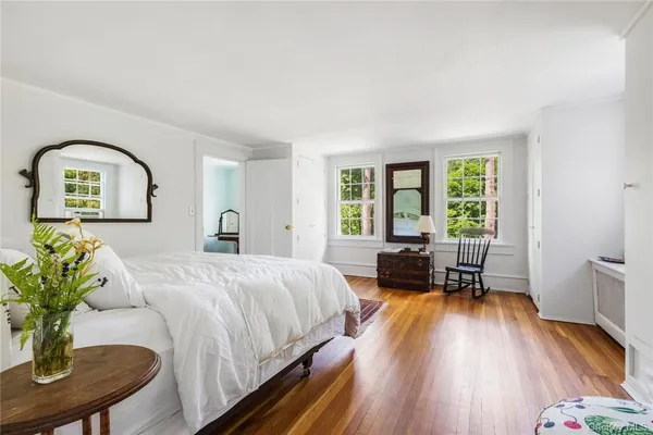 a spacious bedroom with a bed and a window