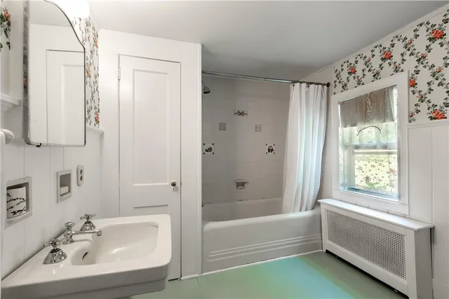 a bathroom with a bathtub and a sink