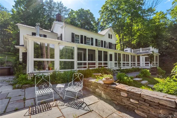 a view of a house with backyard sitting area and garden