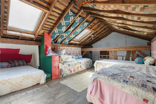 a bedroom with bed and a window