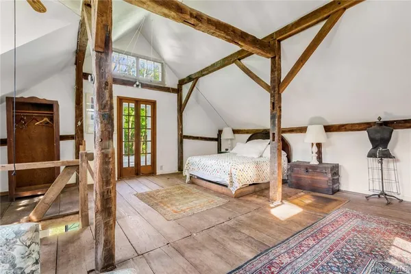 a bedroom with a bed a mirror and a desk