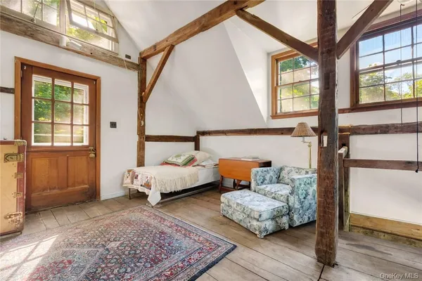 a bedroom with furniture and a window