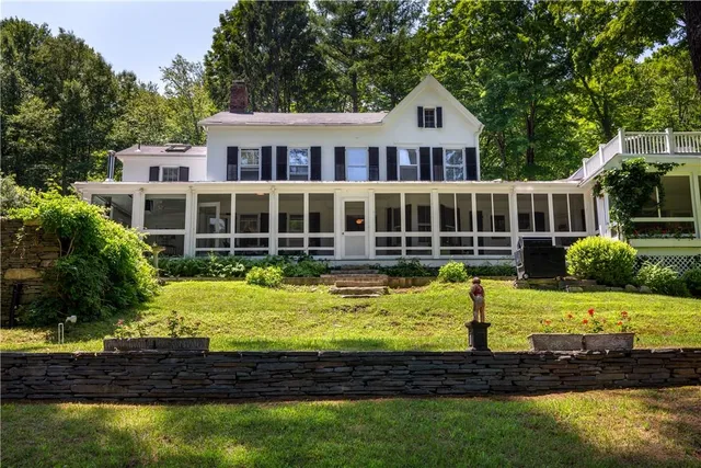 a view of a house with swimming pool and yard