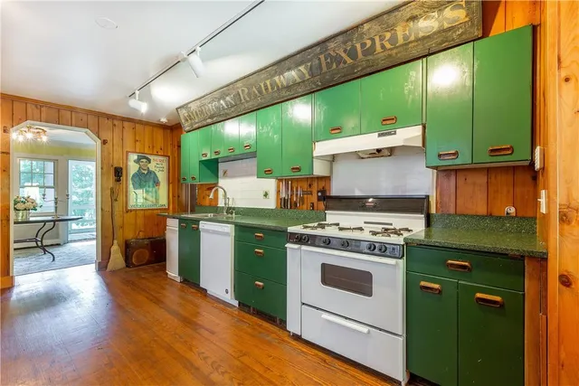 a kitchen with a stove kitchen island a sink and a stove