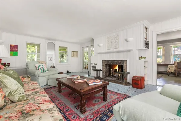 a living room with furniture a fireplace and window