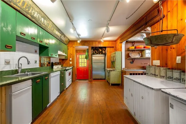 a large kitchen with stainless steel appliances granite countertop a sink and cabinets