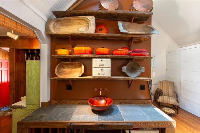 a kitchen with a stove and a wooden floor