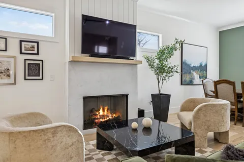 a kitchen with stainless steel appliances granite countertop a sink a stove a refrigerator and island with wooden floor