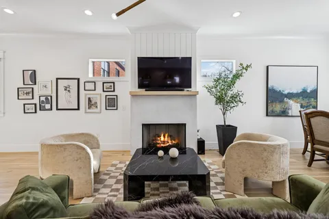 a kitchen with stainless steel appliances granite countertop a stove oven a sink dishwasher and white cabinets with wooden floor