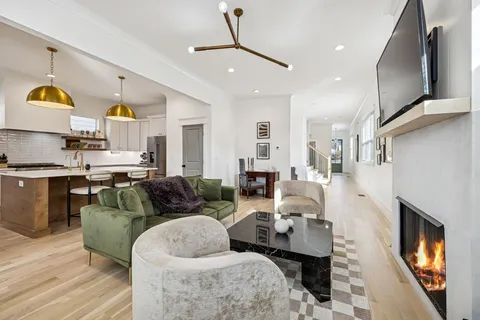 a kitchen with stainless steel appliances a stove a sink a center island and cabinets