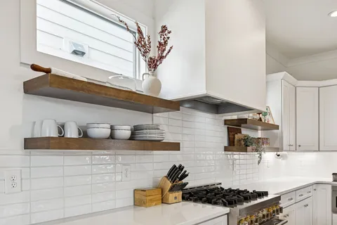 a spacious bedroom with a bed and a chandelier