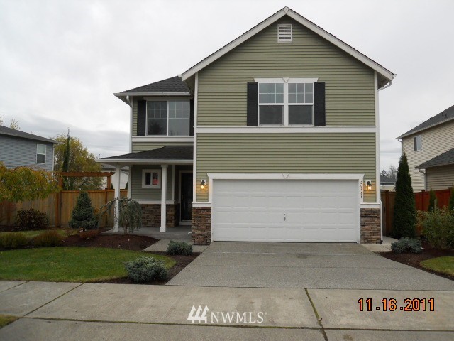 20406 Rustic View Road Southeast Monroe, WA 98272 - Photo 1 of 1 a front view of a house with a yard and garage