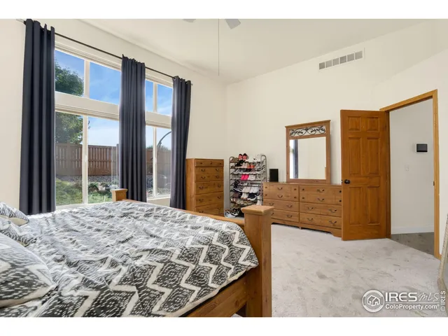 a living room with a bed furniture and a large window