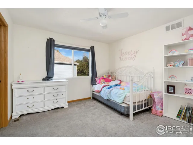 a bedroom with a bed and a dresser in it