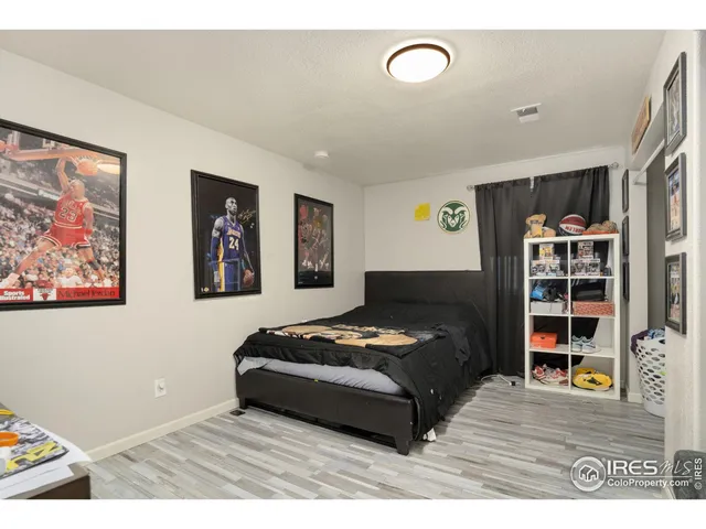 a bedroom with furniture and book shelf