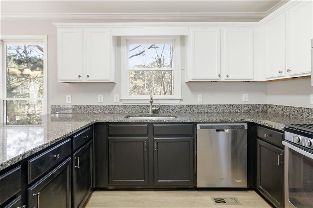 201 Arbor Hills Road North Talking Rock, GA 30175 - Photo 11 of 46 a kitchen with granite countertop white cabinets and black stainless steel appliances