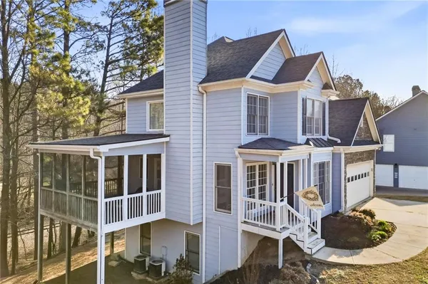a patio with table and chairs and potted plants