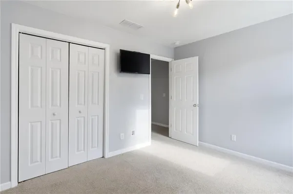 a view of a livingroom with an empty space and a hallway