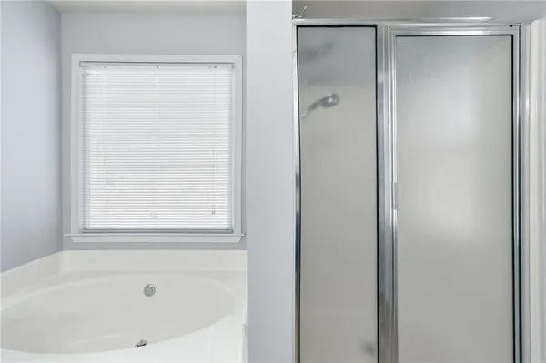 a white bath tub with a shower
